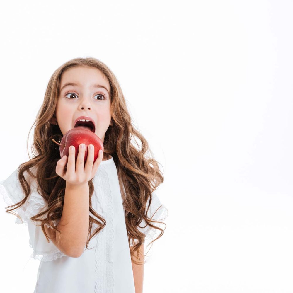 cute-little-girl-holding-eating-red-apple